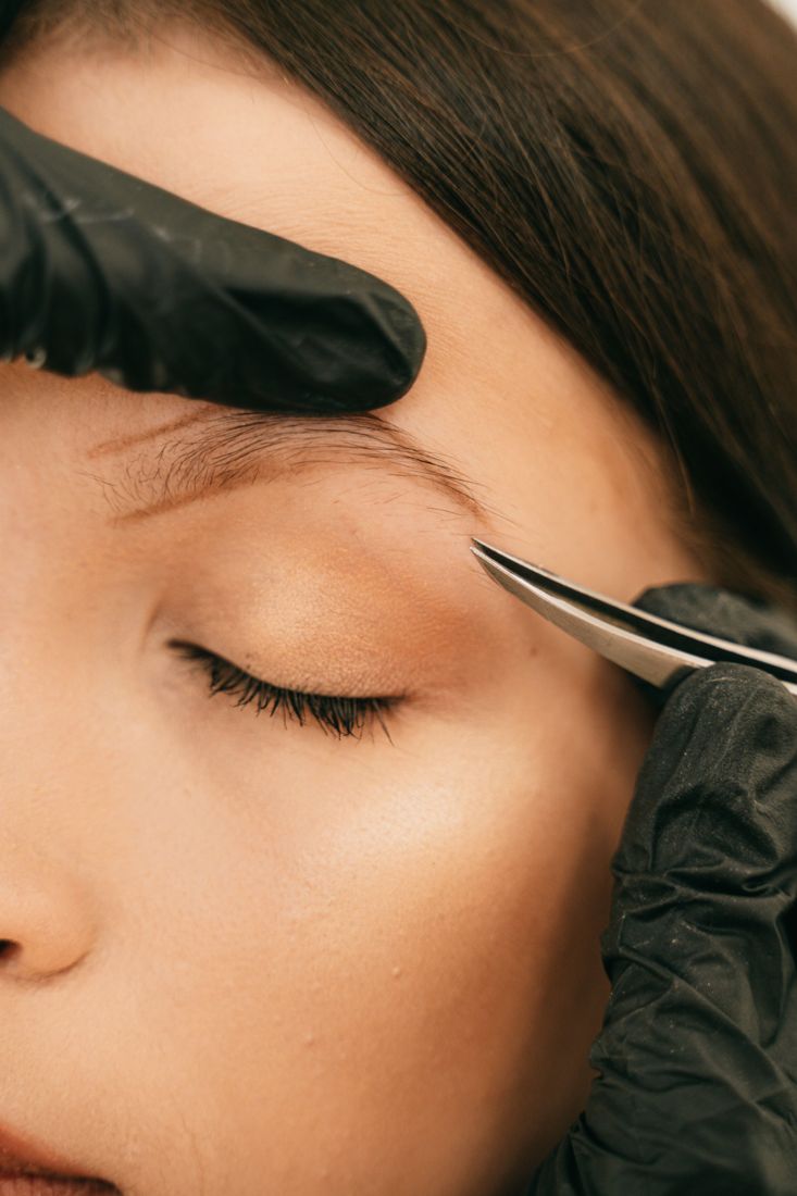 Brow shaping in progress, close-up