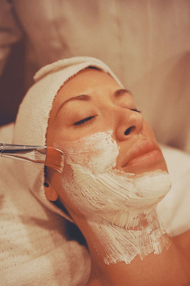 A facial mask being brushed on